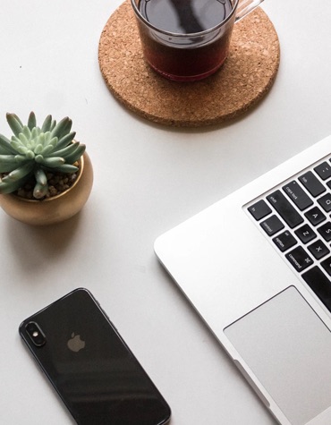 Desk Plant, coffee and a laptop on a white desk